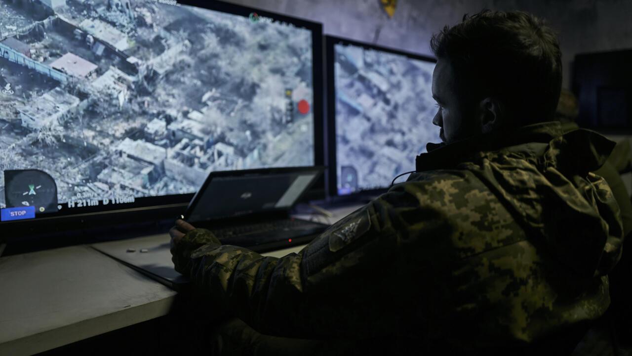 Ukrainian soldiers watch drone feeds from an underground command center. Photo: AP/Libkos.